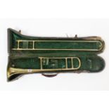 A Corton brass slide trombone, cased.