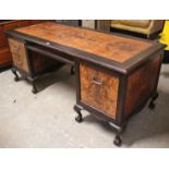 A burr-ash & ebonised-finish large kneehole desk fitted with an arrangement of four drawers, & on