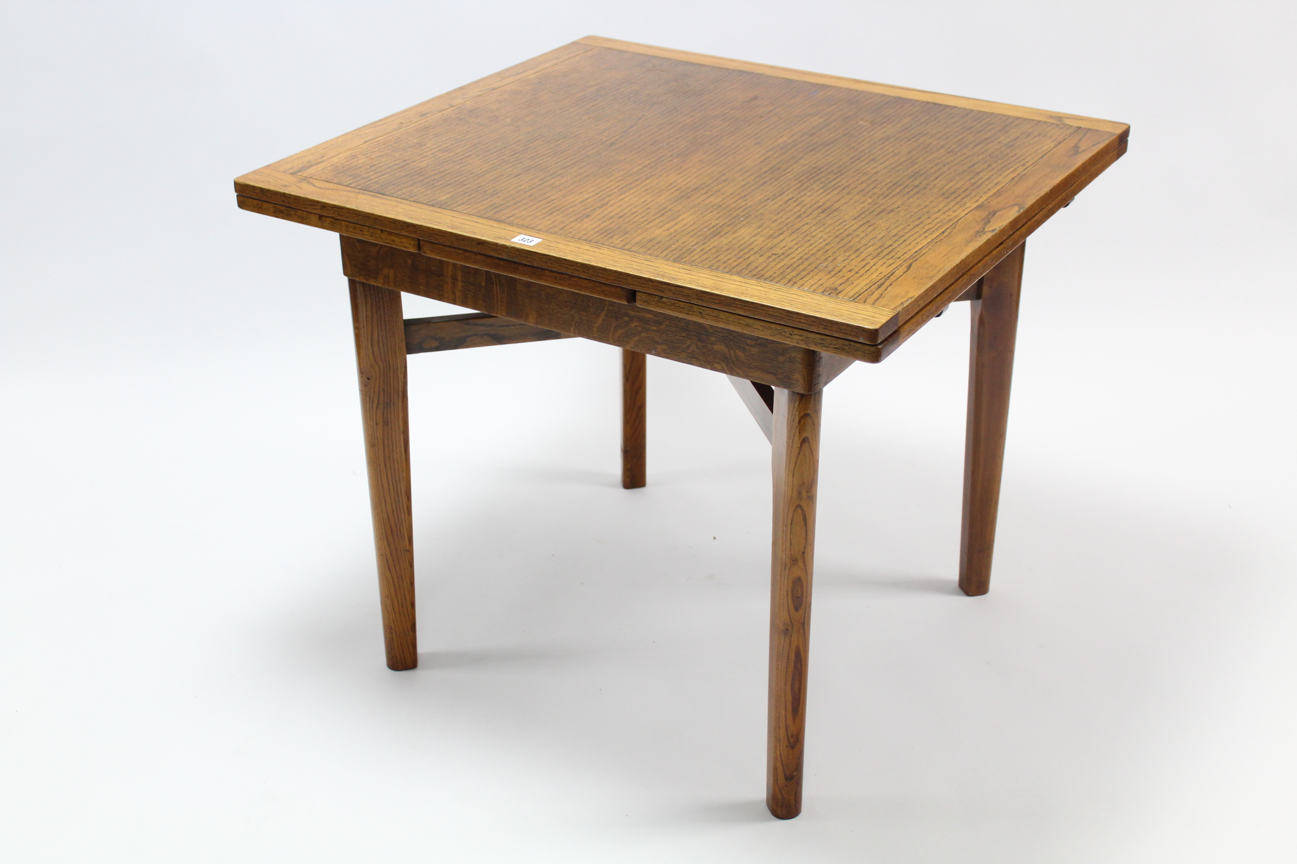 A mid-20th century oak draw-leaf dining table on square tapered legs with diagonal stretchers, - Image 2 of 2