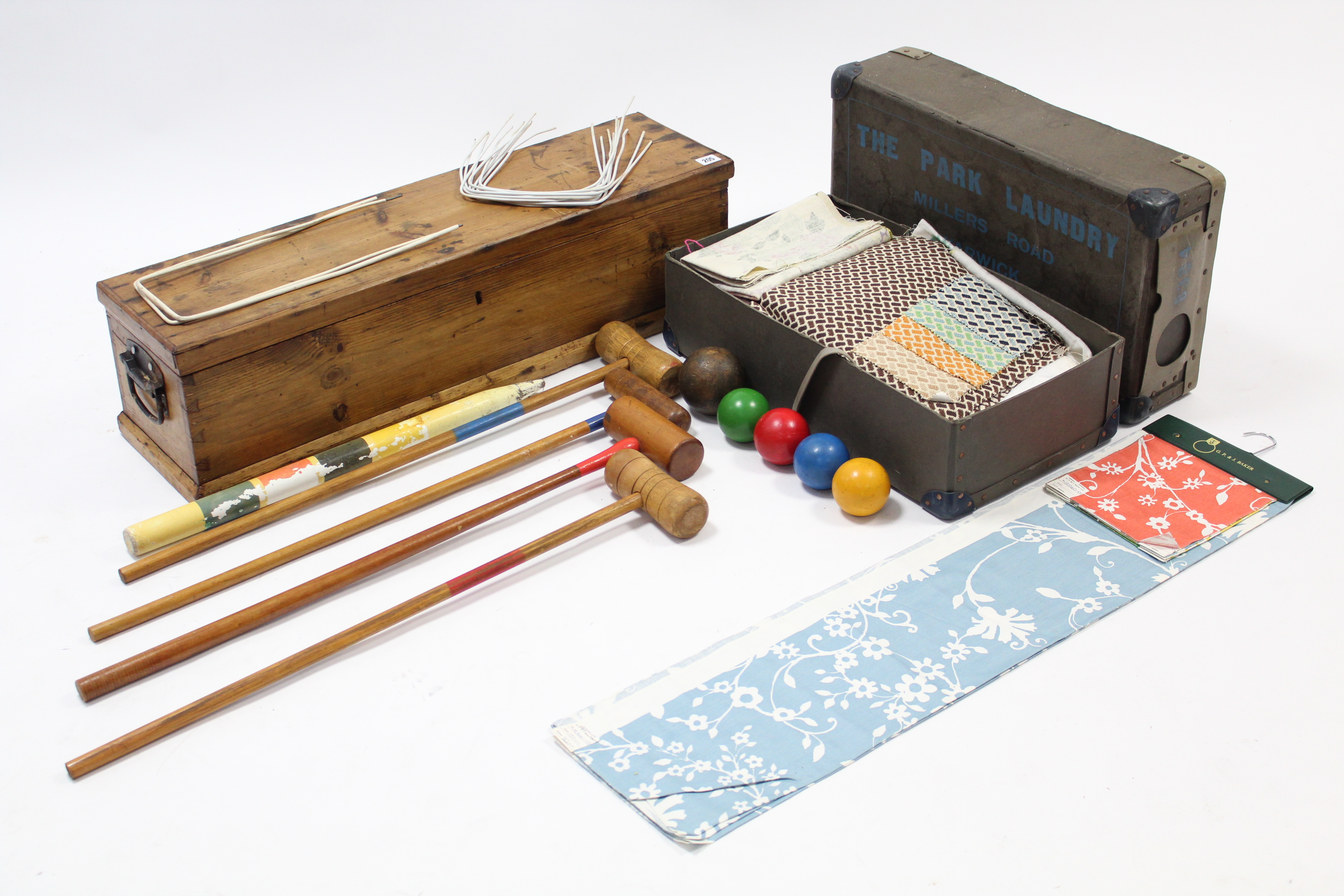 A croquet set in pine case; & various items of household textiles.