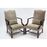 A pair of Gainsborough-type elbow chairs with shaped padded backs & sprung seats upholstered