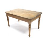 A pine kitchen table with canted corners to the rectangular top, & on turned tapered legs, 52” x