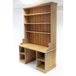 A VICTORIAN PINE DRESSER, the upper part fitted three open shelves & with panelled back, the