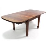 An Edwardian mahogany extending dining table with rounded corners to the rectangular top, pull-out