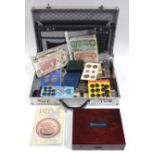 A collection of British & foreign coins, banknotes, coin-sets, commemorative crowns, etc., contained