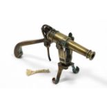 AN ANTIQUE BRASS NAVAL SHIPS SWIVEL-MOUNTED DESK CANNON, WITH TRIGGER ACTION, 8” long.