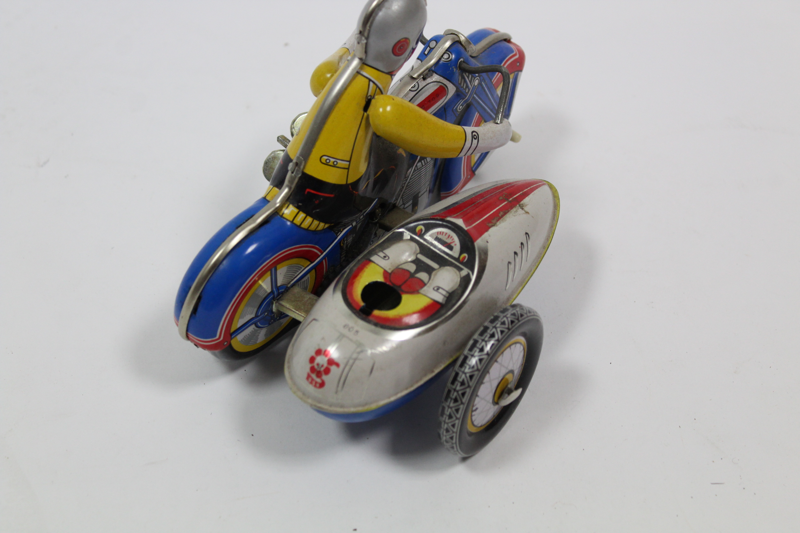 A Chinese clockwork operated lithographed tinplate toy motorcycle & sidecar, unboxed. - Image 3 of 4