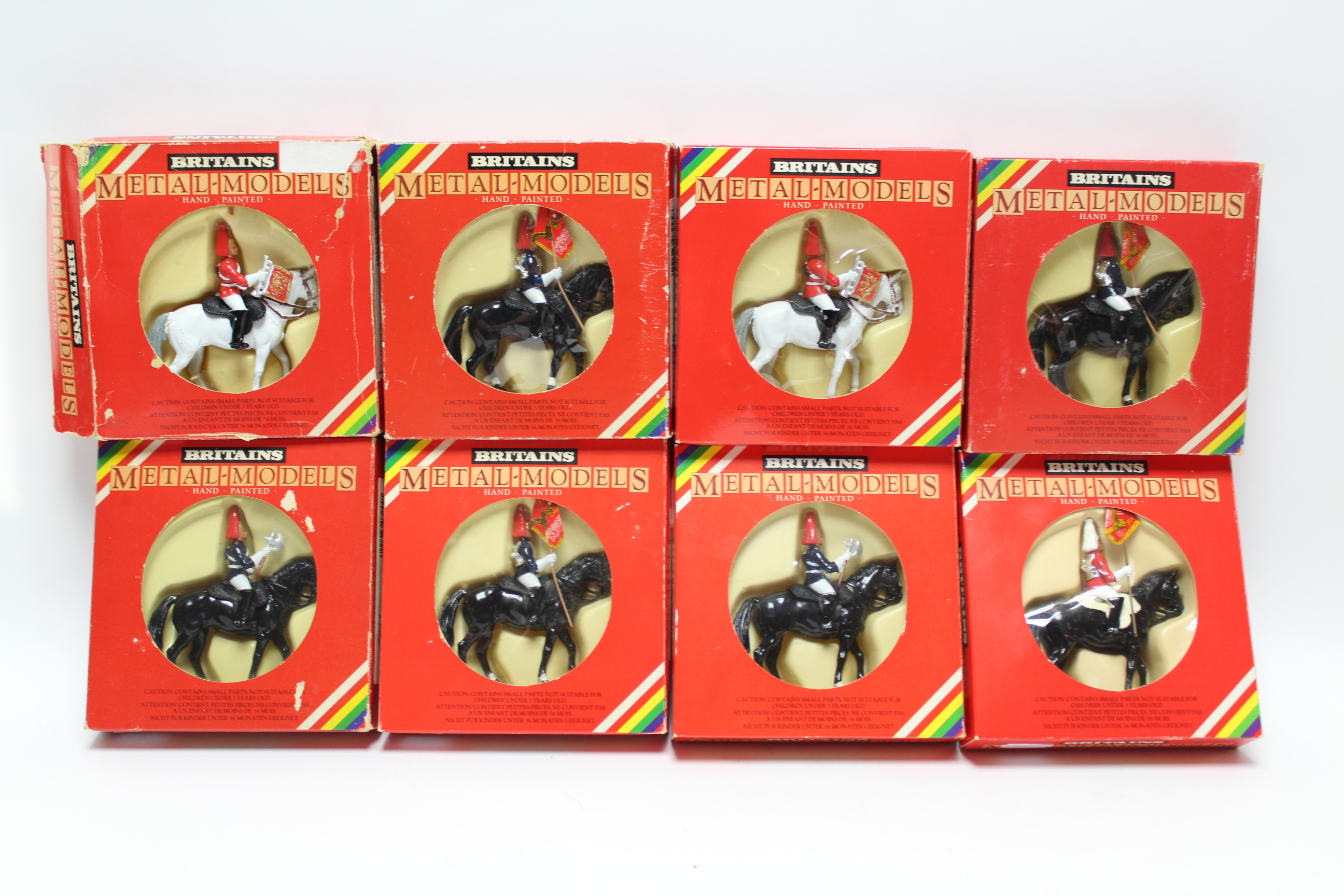 Eight Britains hand painted metal equestrian soldier figures, all boxed.