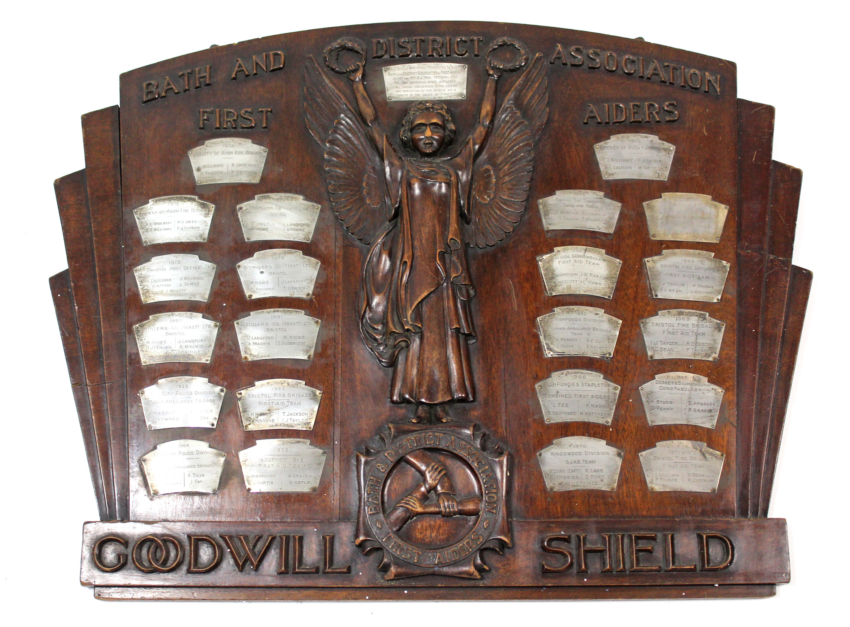 A “BATH AND DISTRICT ASSOCIATION FIRST AIDERS” CARVED WALNUT “GOODWILL SHIELD” BEARS TWENTY-THREE