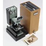 A Watson “Microsystem 70” electric-operated binocular microscope.
