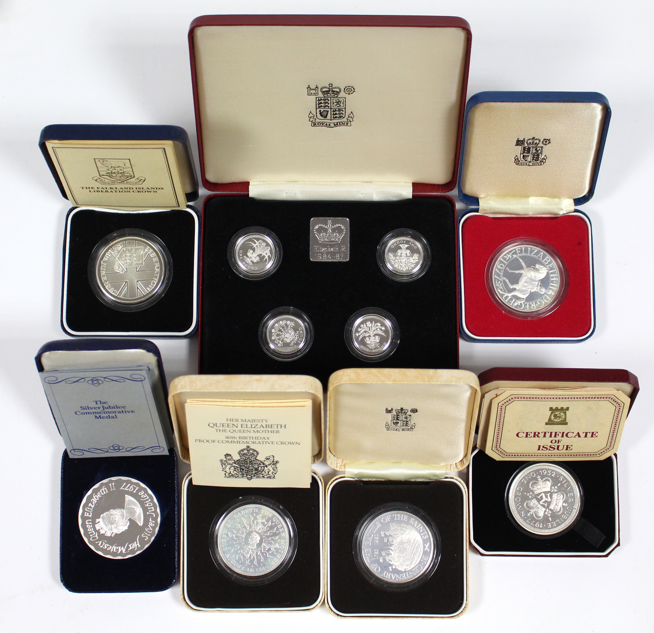 A set of four sterling silver proof £1 coins, 1984-1987, cased; a 1977 Silver Jubilee sterling