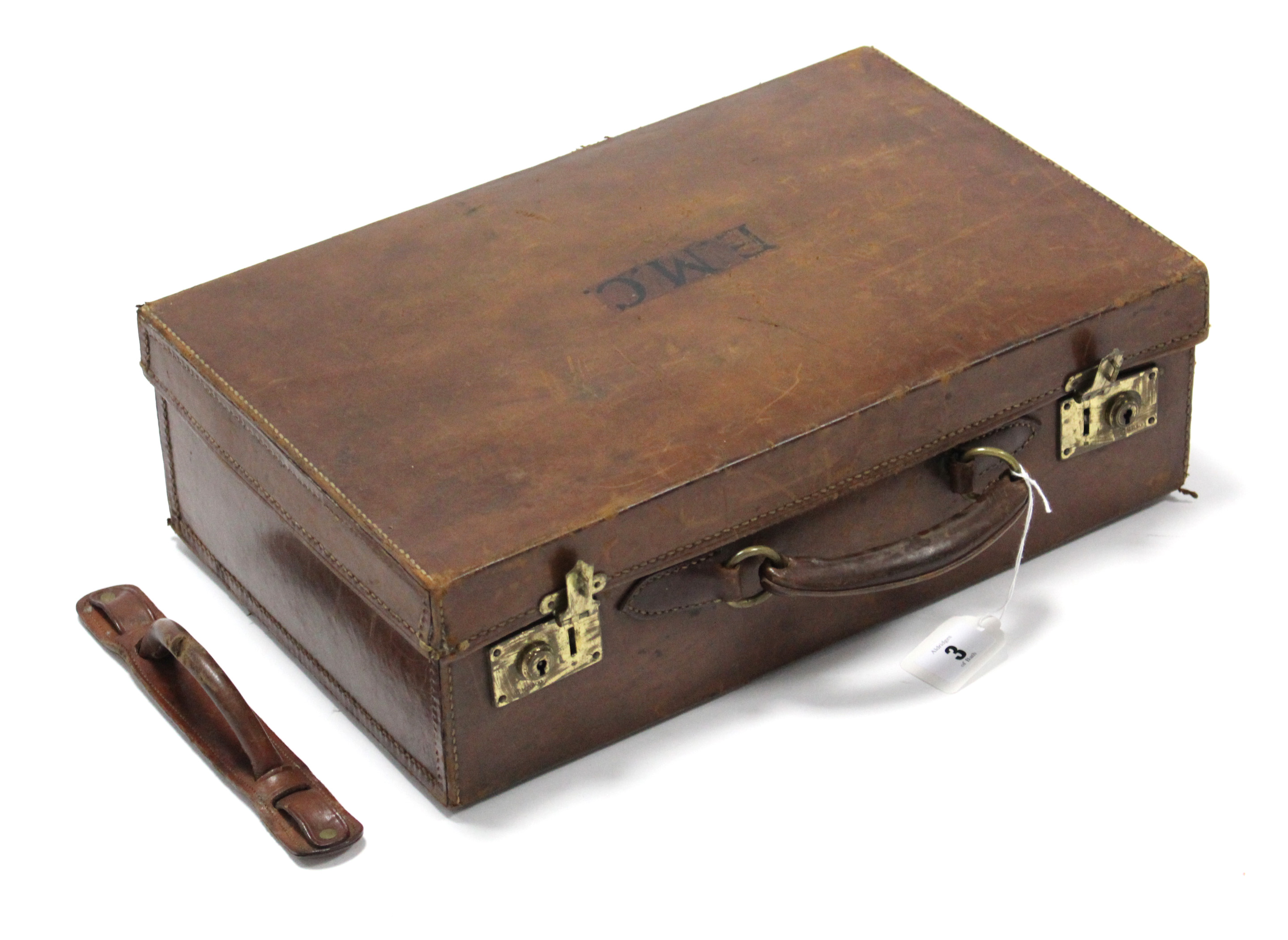 A late 19th/early 20th century small tan leather suitcase fitted brass twin-lever locks, 16” wide;
