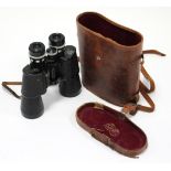 A pair of Kalimar Tru-Zoom 7-12 x 50mm filed glasses with leather case.