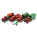 Four early-mid 20th century lithographed tinplate toy trucks.