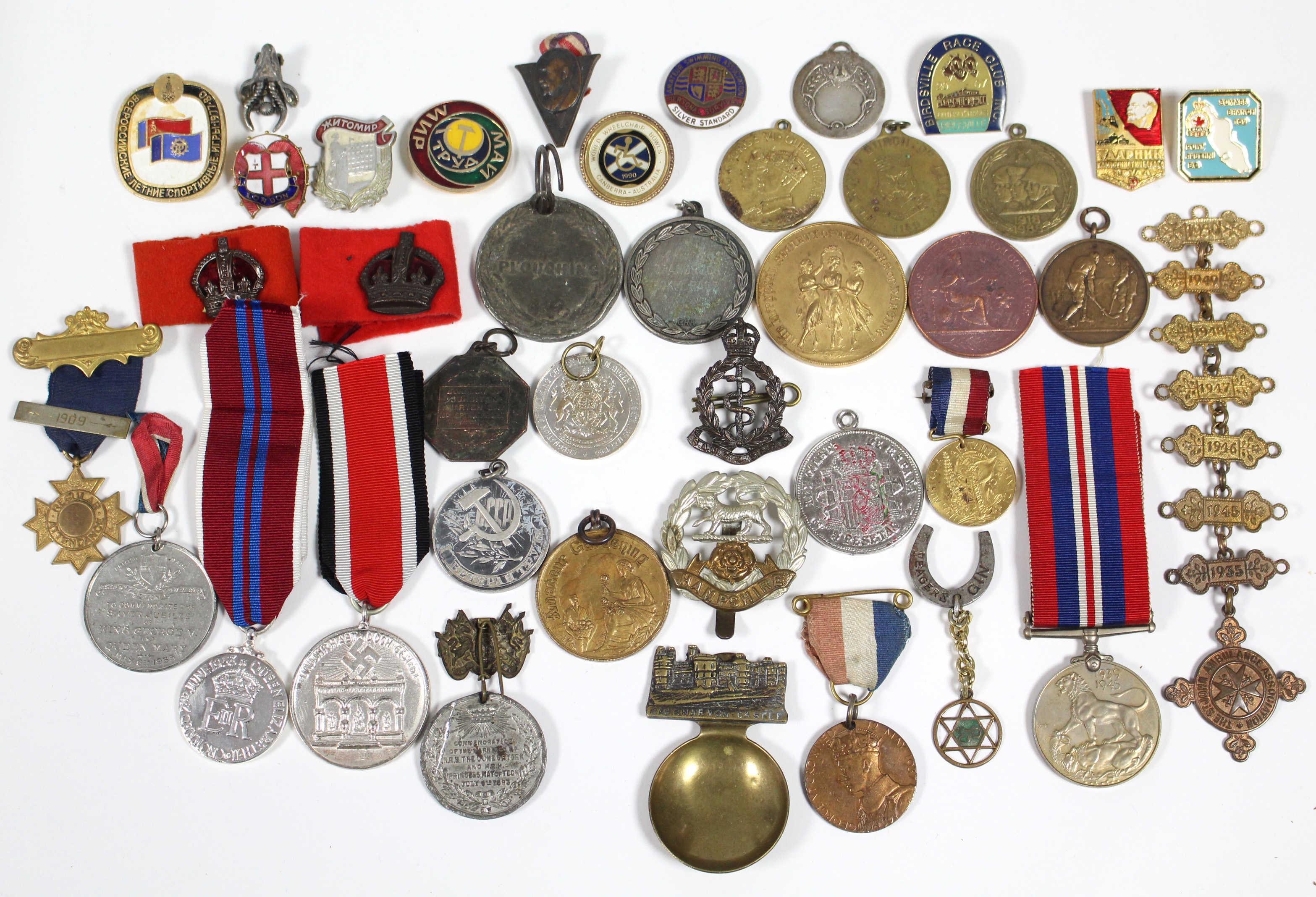 A collection of various medals, enamel badges, etc.