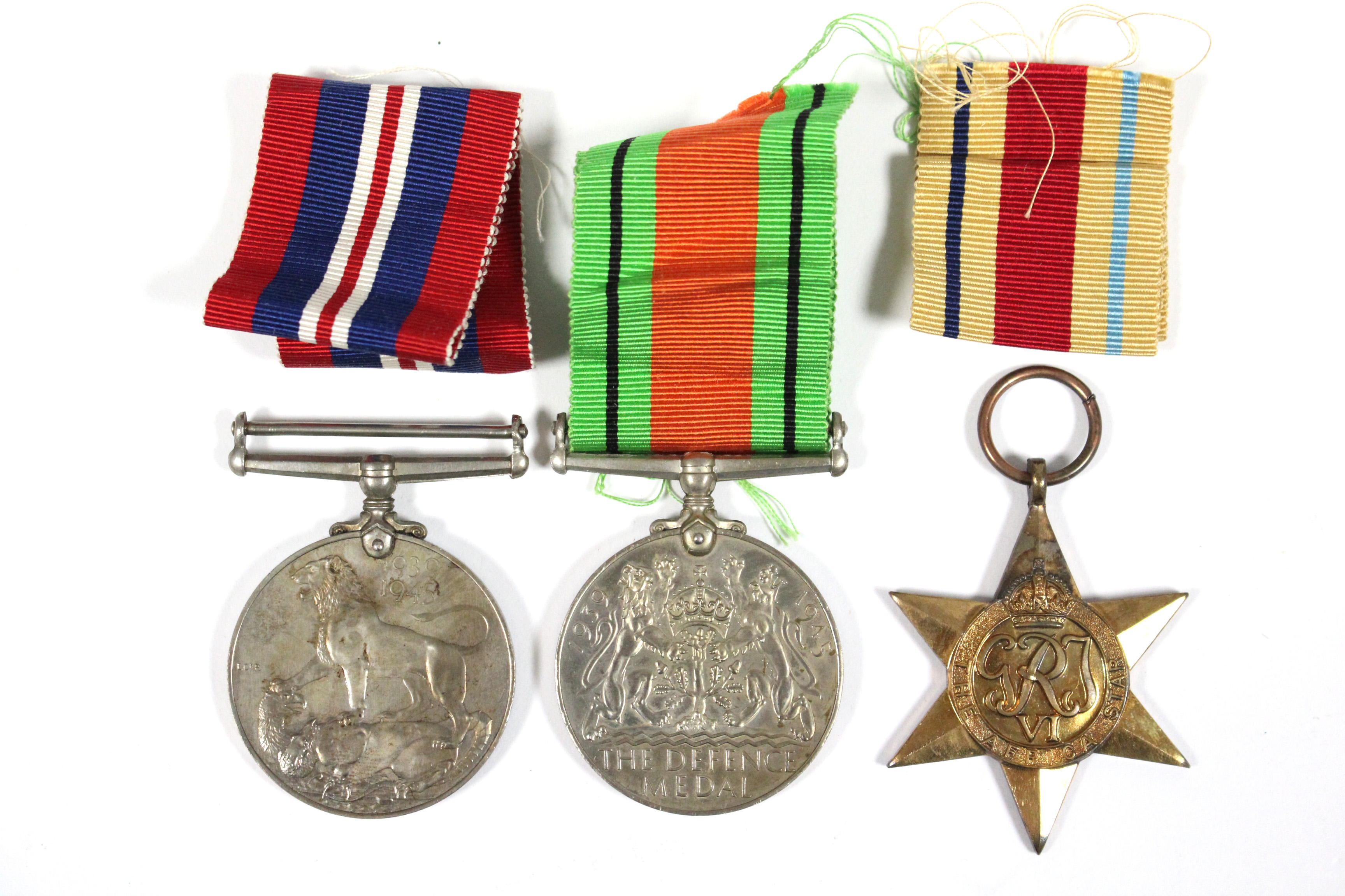 A group of three Second World War service medals:- Africa Star; Defence Medal; & British War