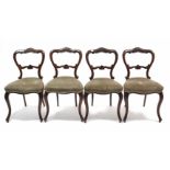 A set of four Victorian simulated rosewood dining chairs with open kidney-shaped backs, padded