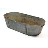 A galvanised-metal oval two-handled bath (holes to base), 48” long.