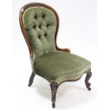 A Victorian carved beech-frame buttoned-back nursing chair, upholstered pale green velour & on short