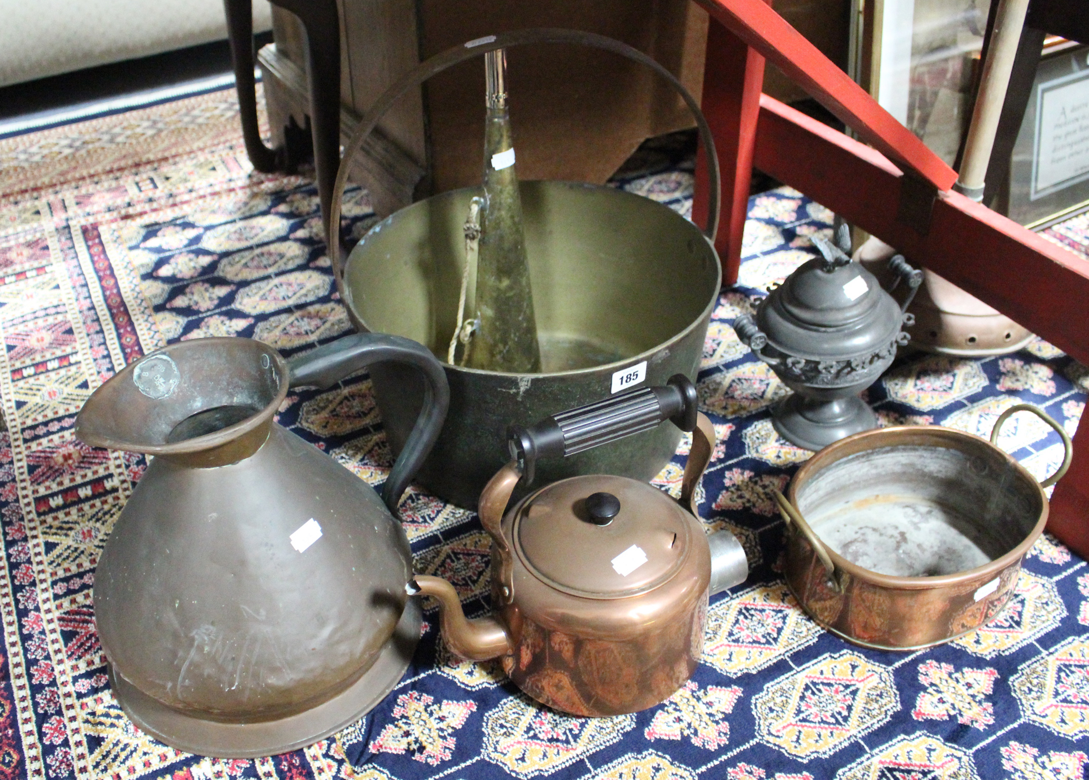A brass preserve pan with iron overhang handle; a copper circular kettle; a wash dolly & various
