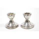 A pair of silver dwarf candlesticks with loaded bases, 2¼” high, Birmingham 1974.