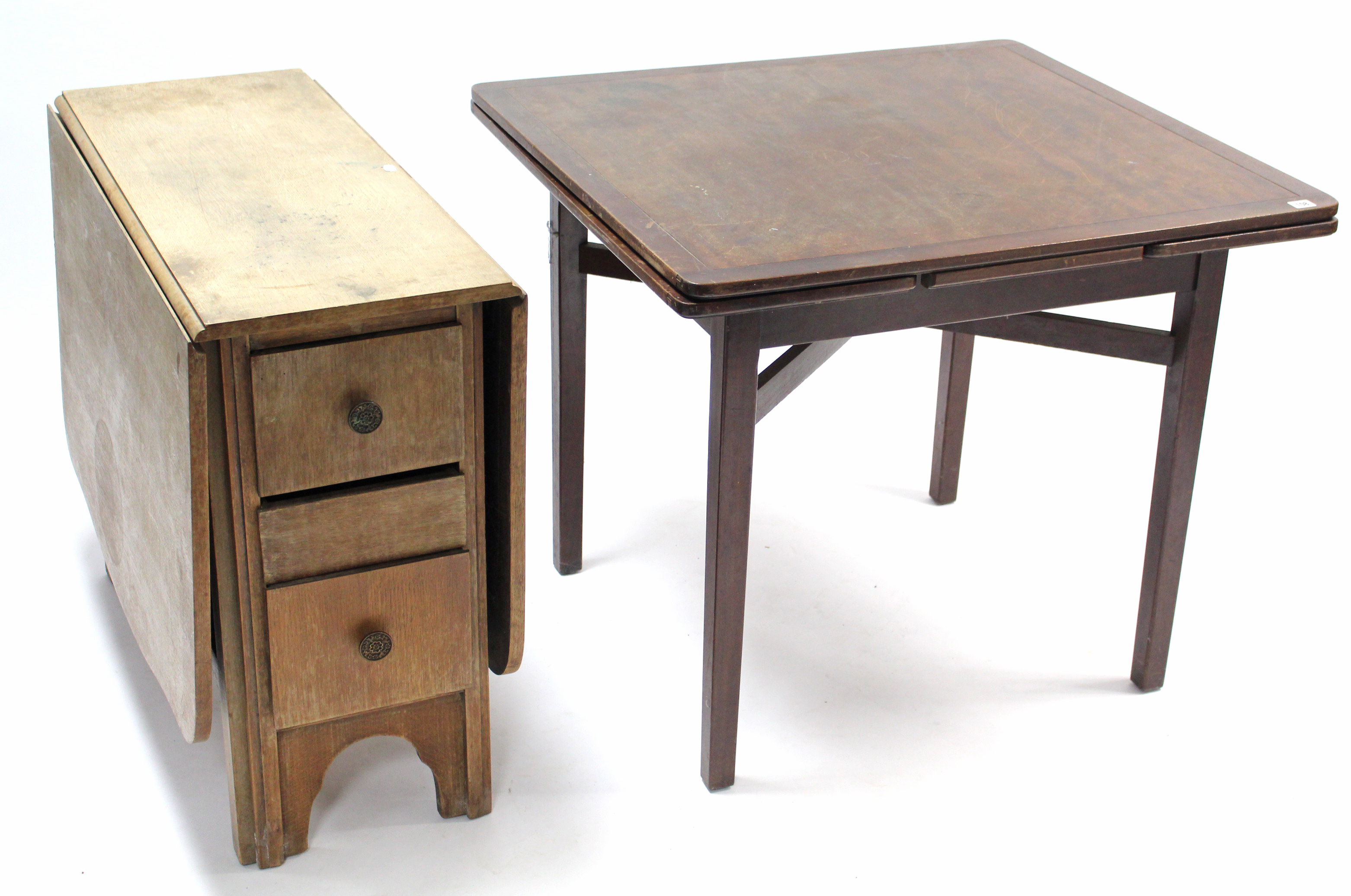 A mid-20th century mahogany draw-leaf dining table on square tapered legs with diagonal stretcher,