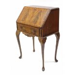 A small mahogany bureau with fitted interior enclosed by fall-front above a long drawer; & on