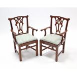 A pair of Chippendale-style mahogany child’s splat-back elbow chairs with padded drop-in-seat, &