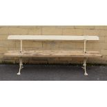 An early/mid-20th century white painted wooden & cast-iron tram bench on X-shaped end supports, 78¾”