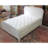 A continental-style white painted wooden 5’ 6” bedstead, complete with mattress.