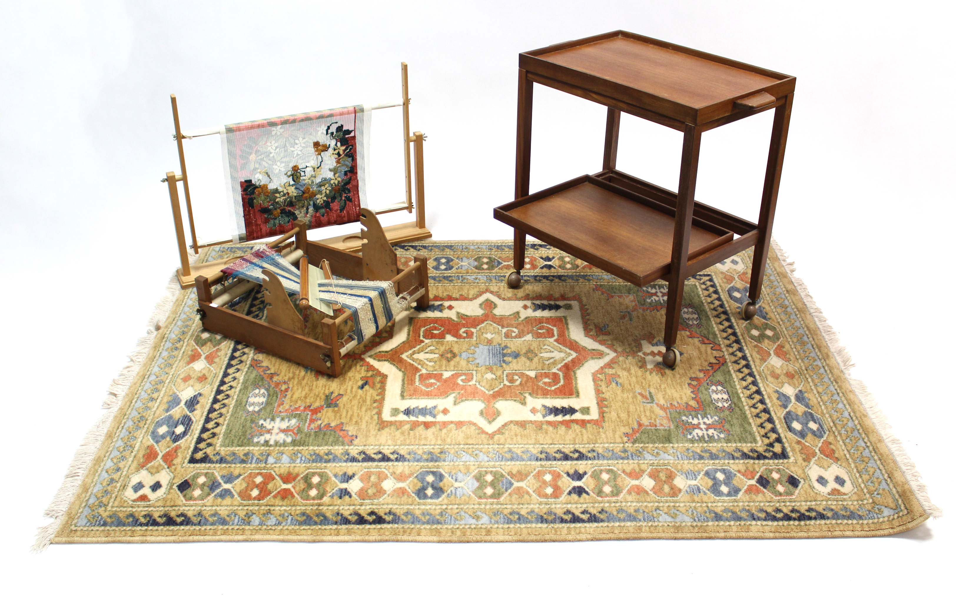 A teak rectangular two-tier tea trolley, 24” wide; together with a Belgian rug; & two tapestry