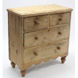 A pine small chest fitted two short & two long graduated drawers with turned knob handles, shaped