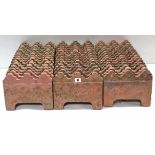 A set of forty-six terracotta-coloured edging tiles, 10¼” wide x 8” high.