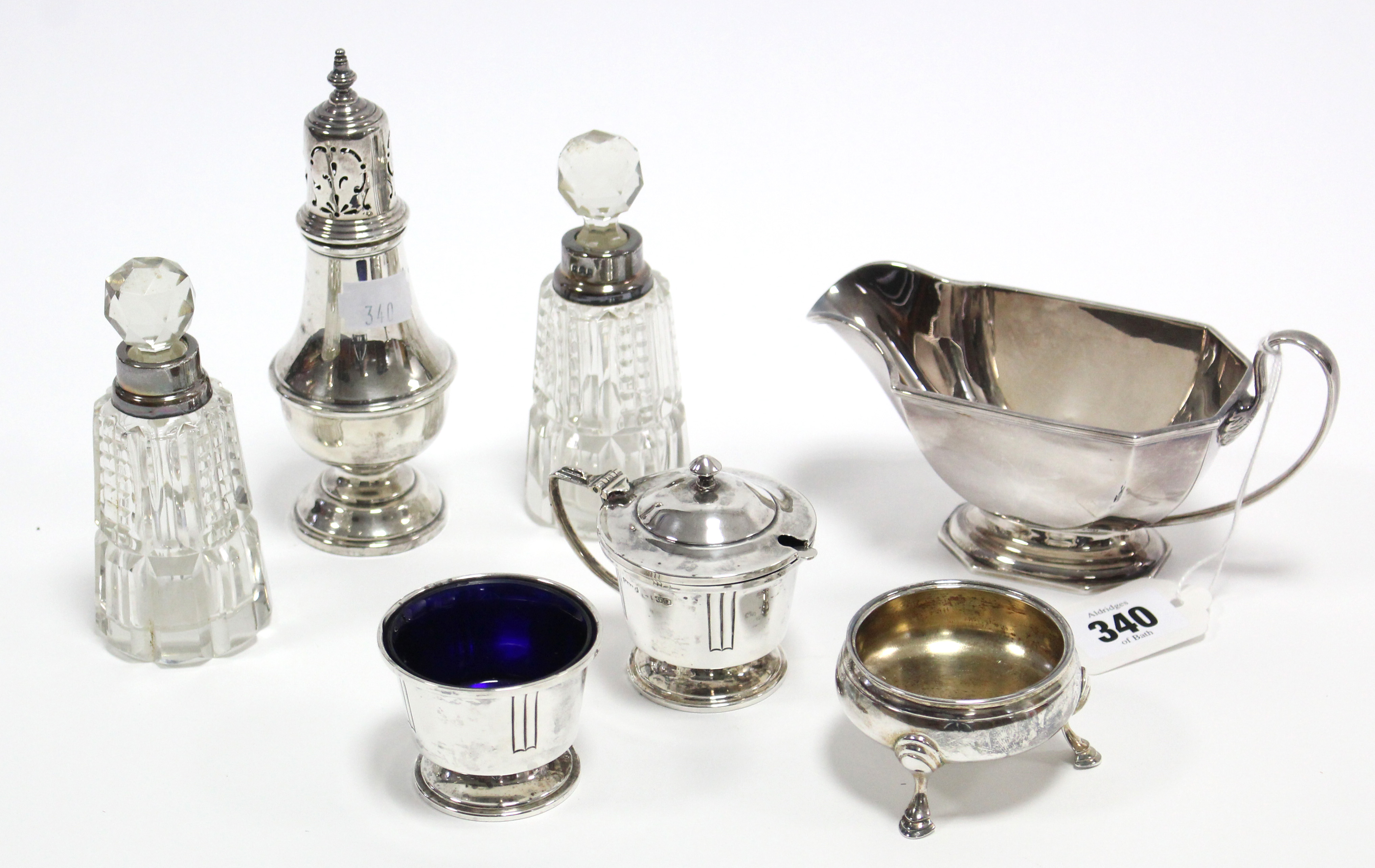 A George V silver sauce boat, 3” high, Birmignhamm1934; a George VI silver pepper pot, 5½” high,