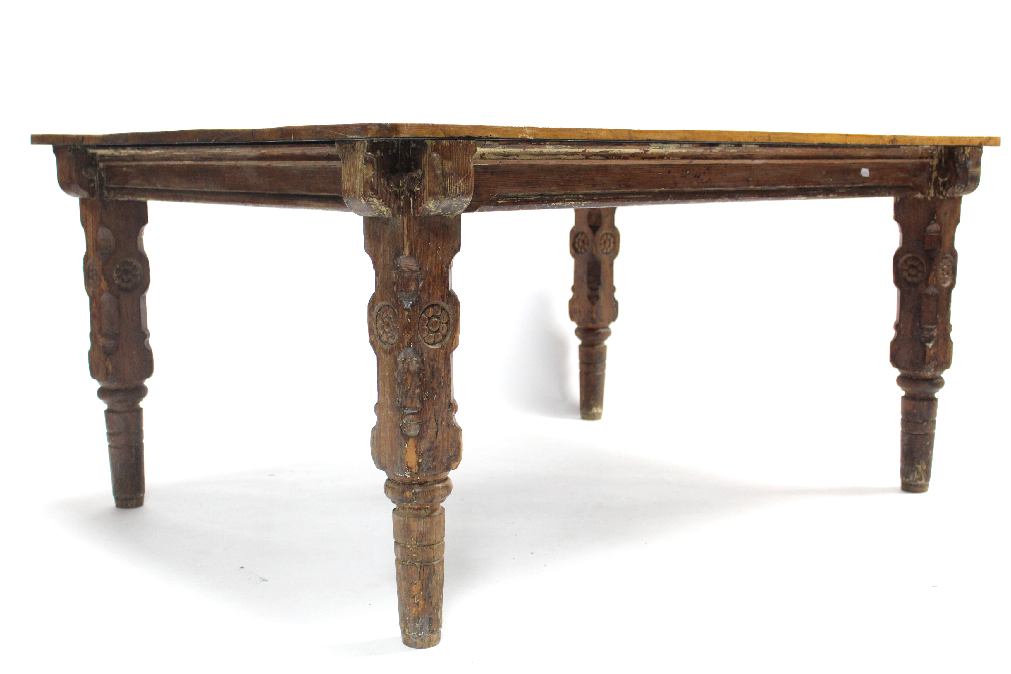 A Victorian pitch pine kitchen table on carved & turned legs, the later pine rectangular top with