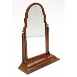 An early 20th century figured mahogany rectangular swing toilet mirror on platform base, 34” high.