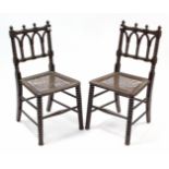 A pair of early 20th century oak bobbin-frame occasional chairs with woven-cane seats.
