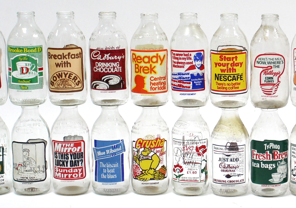 Thirty-four various advertising milk bottles.