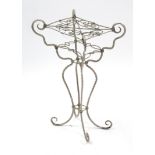 A white painted wrought-iron jardinière stand on four shaped legs, 16½” wide x 27½” high.