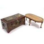 An oriental carved camphor wood trunk with figure scene decoration to the hinged lift-lid & sides, &