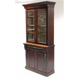 A Victorian mahogany tall bookcase, the upper part with three adjustable shelves enclosed by pair of