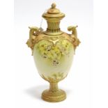 A late 19th century Royal Worcester porcelain ovoid two-handled vase & cover with yellow & white