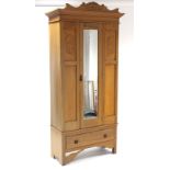 A late Victorian carved walnut bedroom pair comprising a single-door wardrobe, 37¾” wide x 81” high,