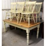 A pine kitchen table with rounded corners to the rectangular top, the cream painted underside on