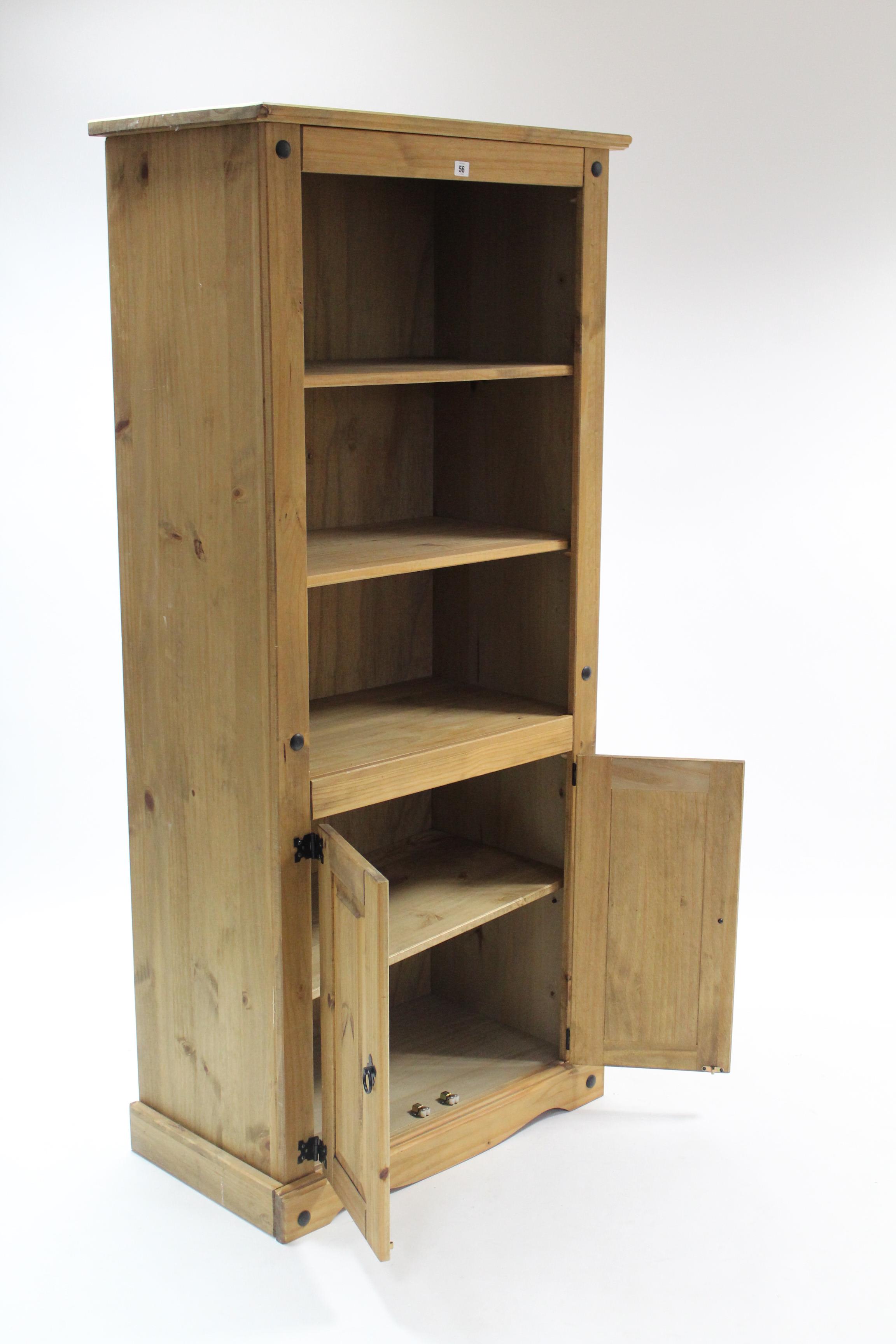 A pine tall standing bookcase with two open adjustable shelves above cupboard enclosed by pair of - Image 2 of 2