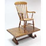 A late 19th/early 20th century lath-back elbow chair with hard seat, & on turned legs with spindle