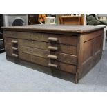 A late 19th/early 20th century pitch pine plan chest, fitted four long drawers with block handles,