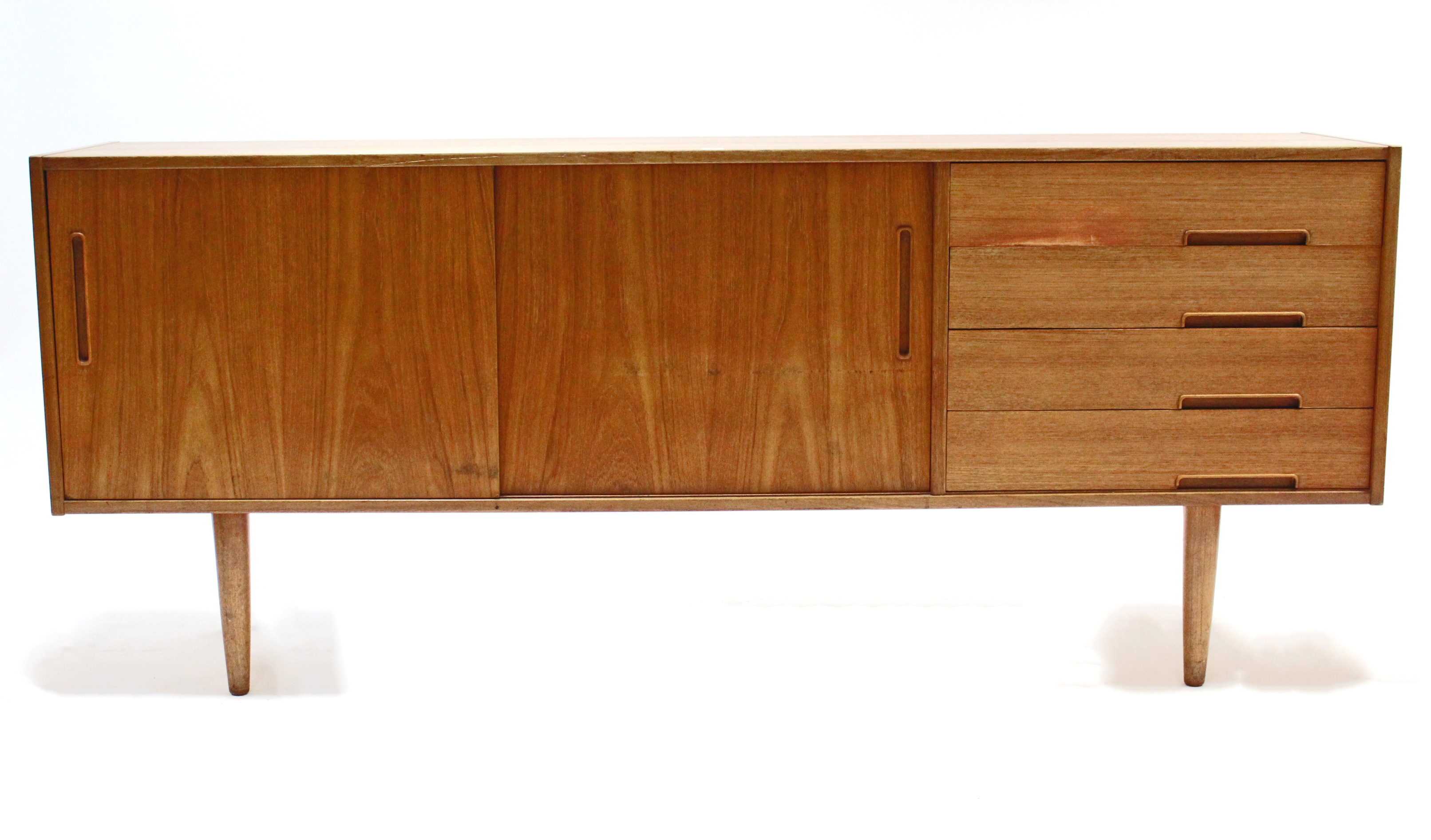 A 1960’s TROEDS OF SWEDEN “TRENTO” TEAK SIDEBOARD fitted four long drawers to the right-hand side,