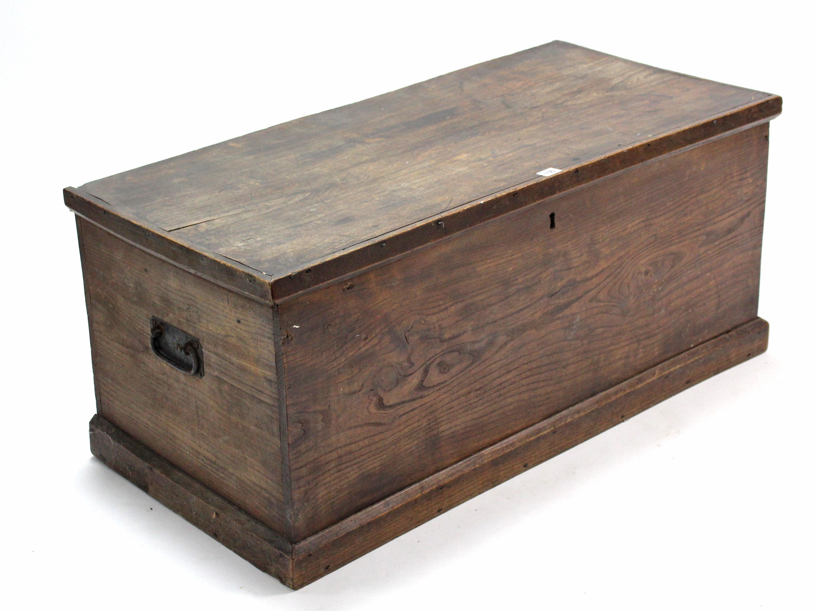 A 19th century elm blanket box with hinged lift-lid, wrought iron side handles, & on plinth base,