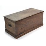 A 19th century elm blanket box with hinged lift-lid, wrought iron side handles, & on plinth base,